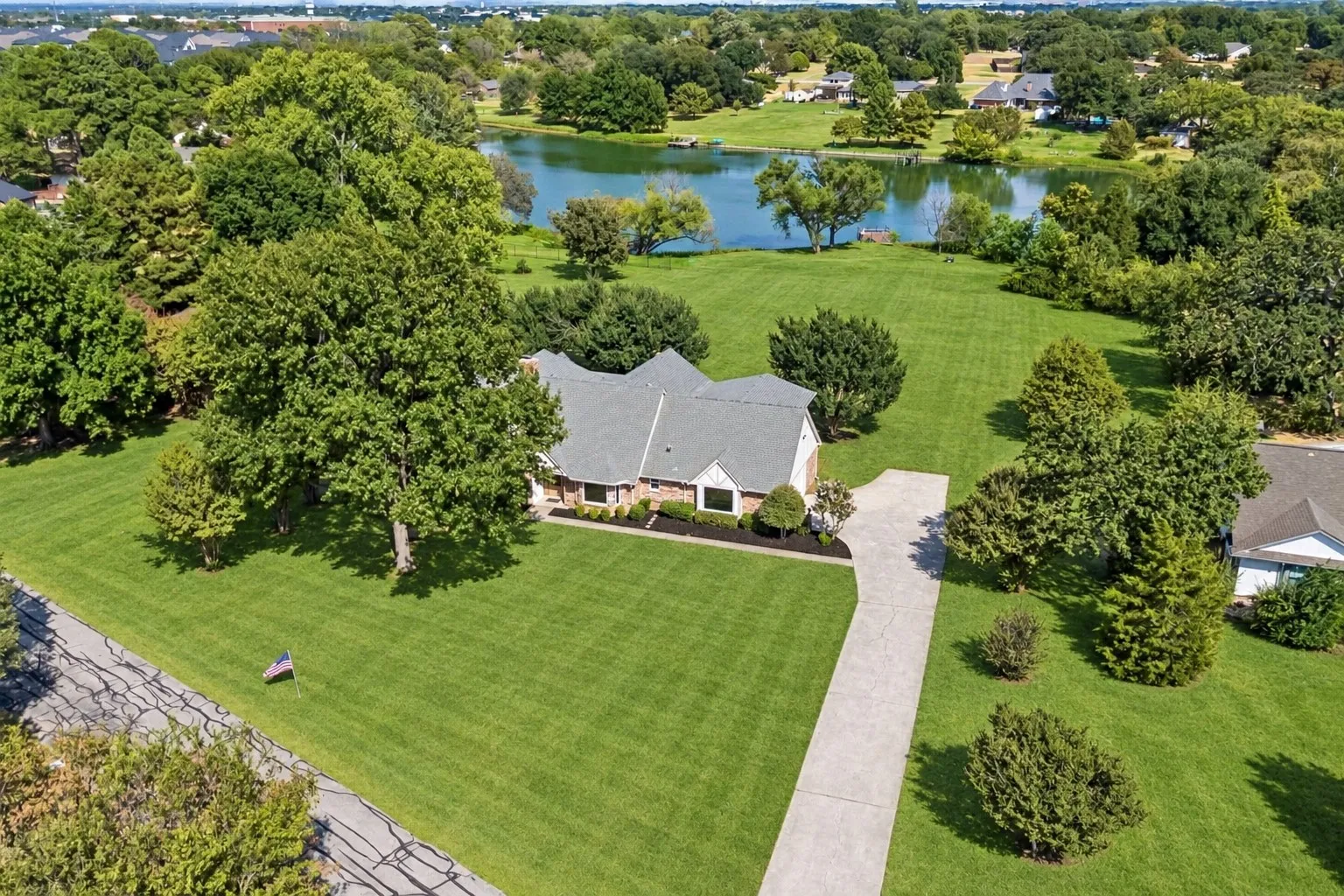 Aerial view of The Pond House and private pond at 131 Oak Grove Circle in Double Oak